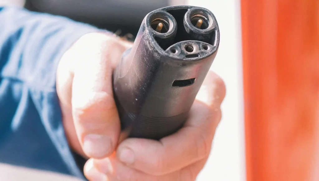 Close-up view of the Tesla NACS charging connector to know nacs vs ccs