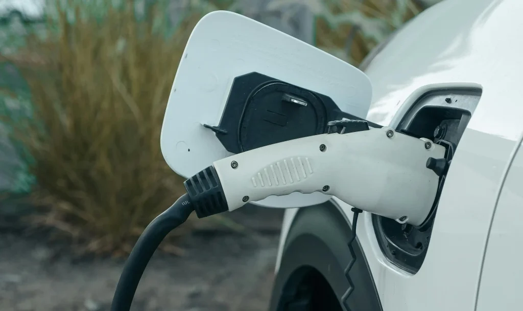 CCS charging connector plugged into an electric vehicle to know differences NACS VS CCS