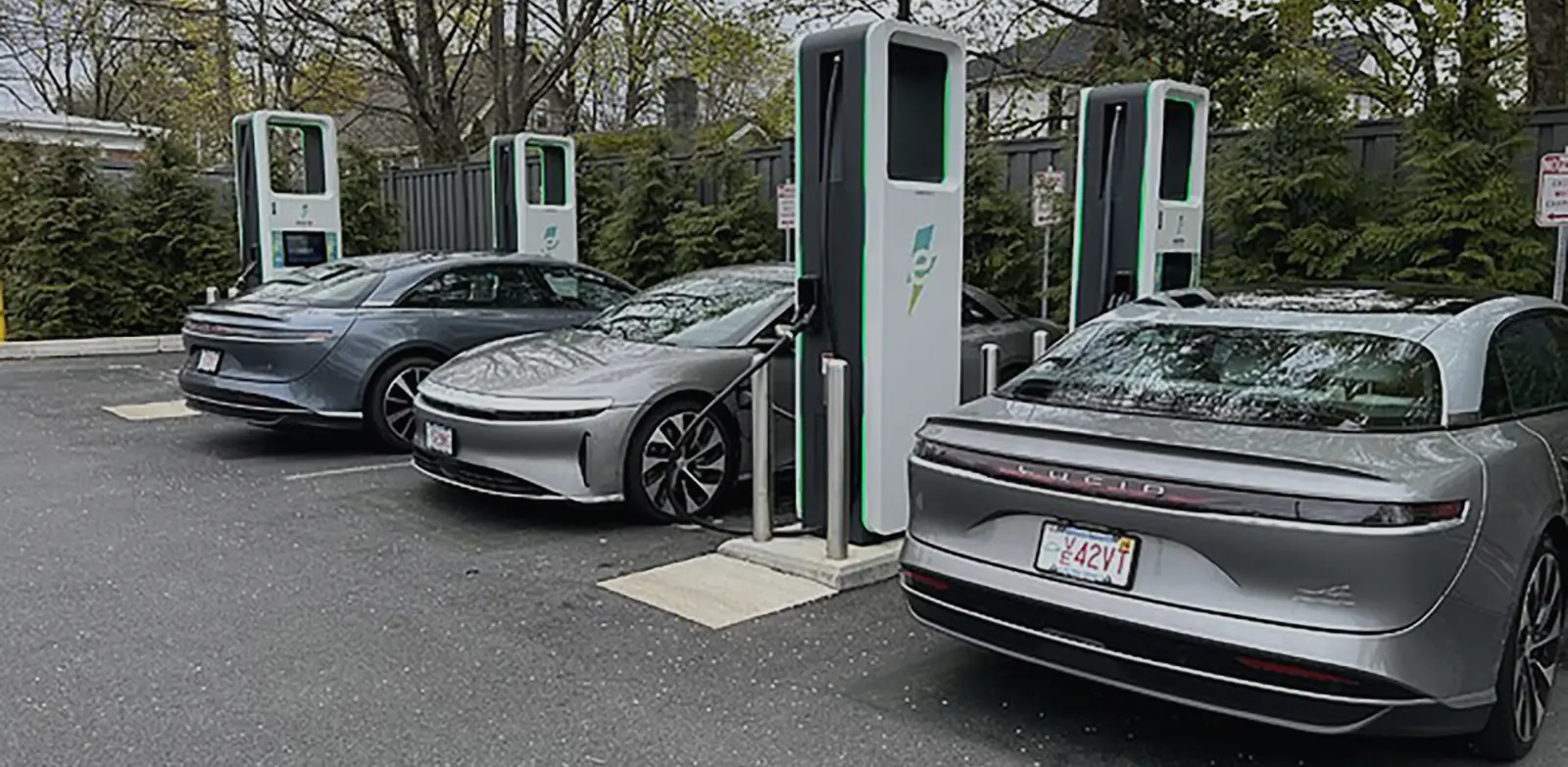 Several silver Lucid Air vehicles charging at a CCS fast charging station.
