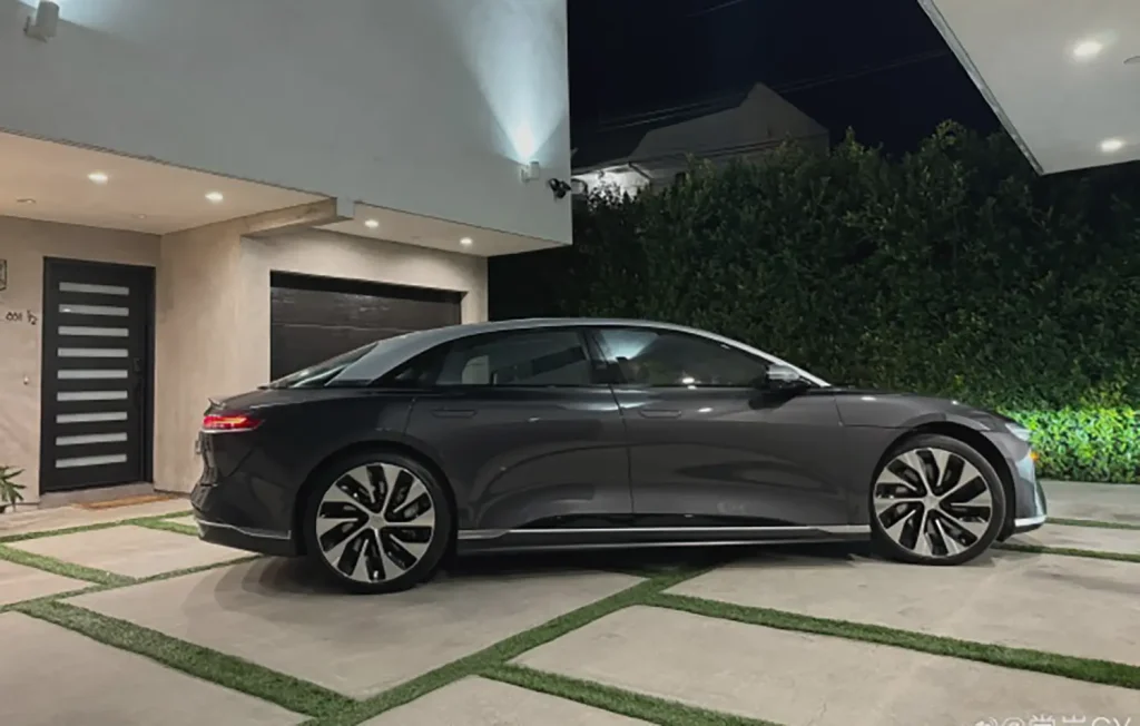 Electric vehicle parked at night with portable EV charger option
