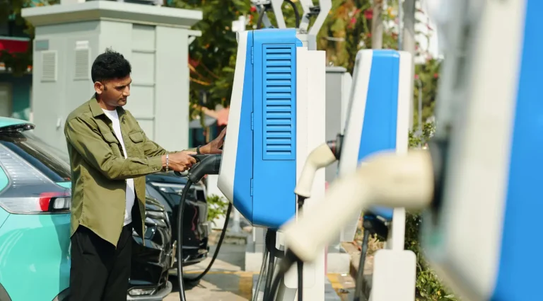 Resident using an EV charging station in a condo parking area