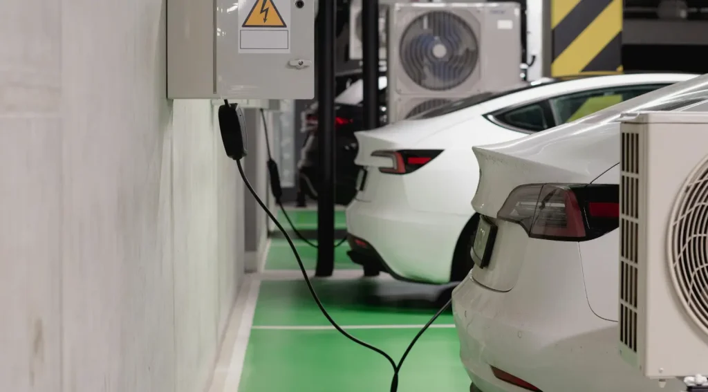 Difference between level 1 and level 2 ev chargers : Two electric vehicles plugged into Level 1 ev chargers mounted on a garage wall