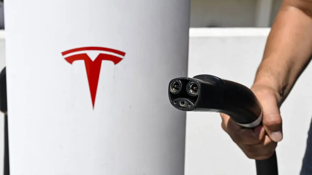 Tesla NACS charging connector close-up with Tesla logo