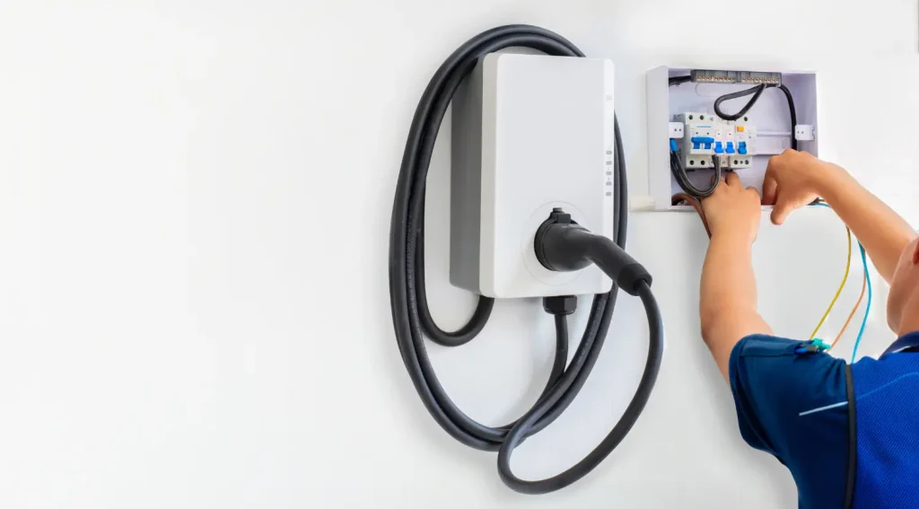 after get ev charger permit, Licensed contractor wiring a Level 2 EV charger
