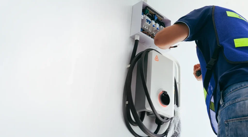 Certified electrician installing a wall-mounted EV charger