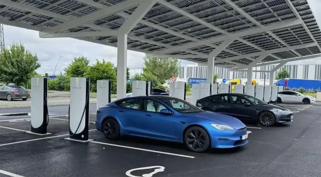 Tesla vehicles charging at a multi-charger station with EV Charger Load Management enabled