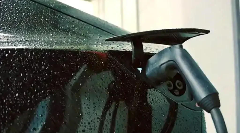 Tesla charge port covered in rain while charging