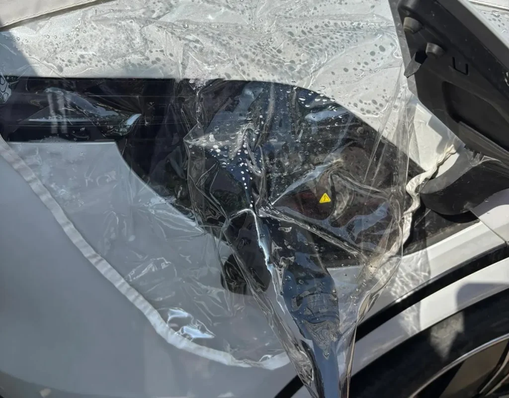 Charging EV in the rain with protection plastic cover