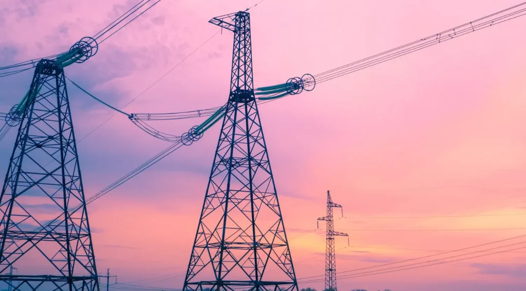 Power lines at sunset representing grid stability with V2G systems