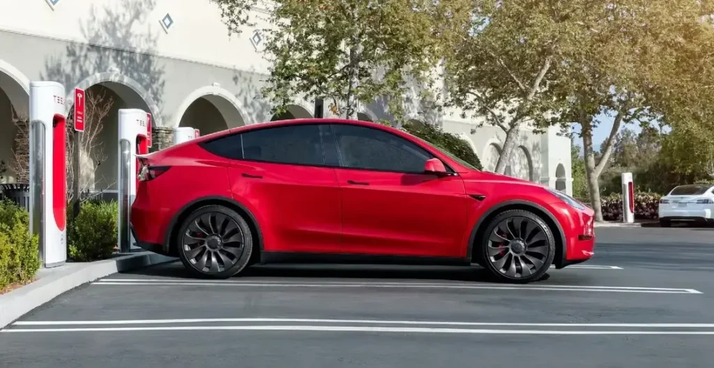 Tesla Model Y charging at a Supercharger station showing Tesla Model Y charge time