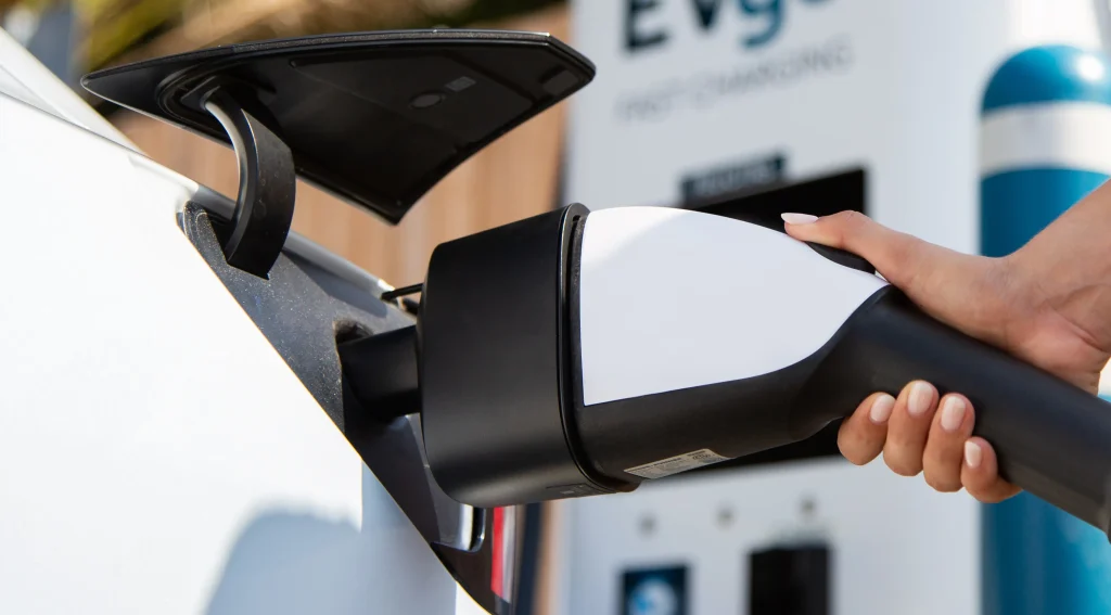 Close-up of a CCS connector being plugged into an EV for Level 3 DC fast charging