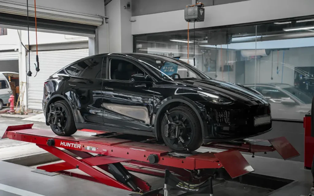 Tesla mileage inspection on a high-mileage used Tesla in a service shop