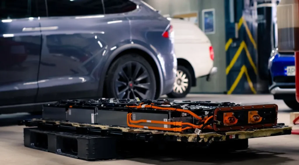 Removed Tesla battery pack showing real tesla battery replacement cost factors