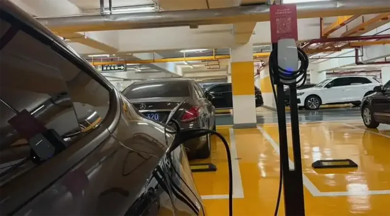 Tesla destination charger installed in a parking garage for convenient Level 2 charging