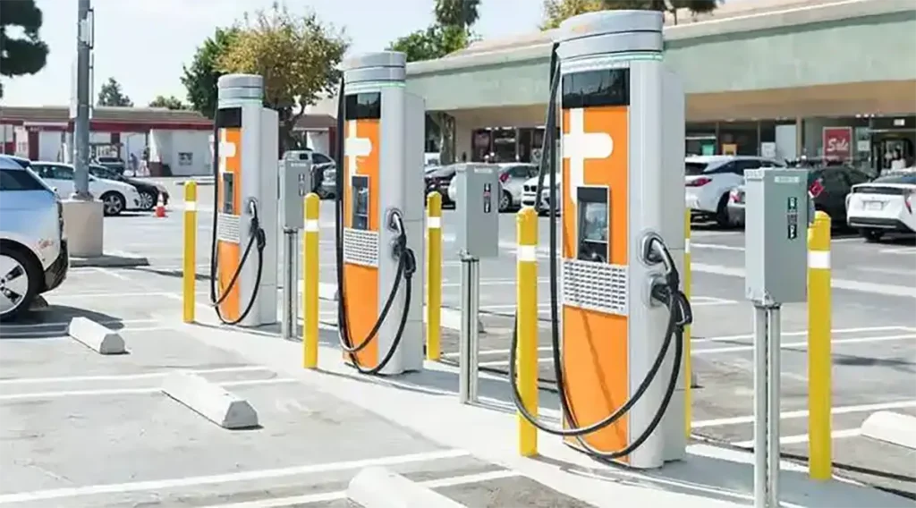 Driver using an EV charging app to locate nearby charging stations