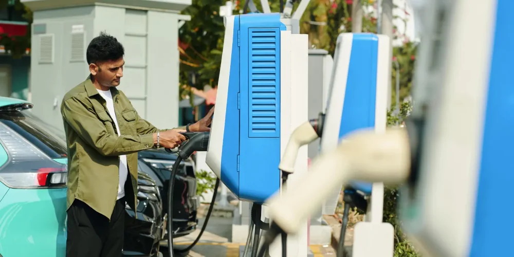 1. EV Charging Stations for Condos – Modern Charging Setup Resident using an EV charging station in a condo parking area