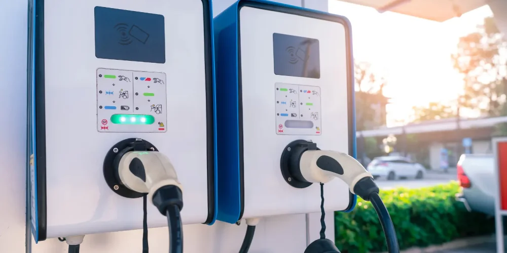 1. what is evse Two wall-mounted EVSE units charging electric vehicles at a public station