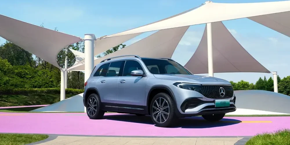 How to charge Mercedes EQB: parked in front of huge umbrella area in a park rest area.
