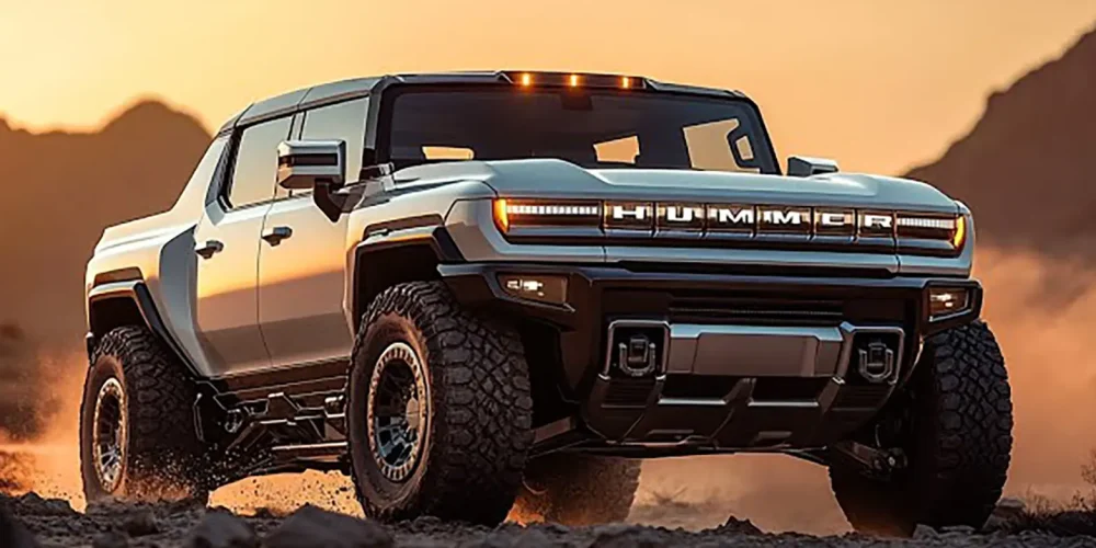 Hummer EV Pickup driving off-road on a rugged terrain at sunset.